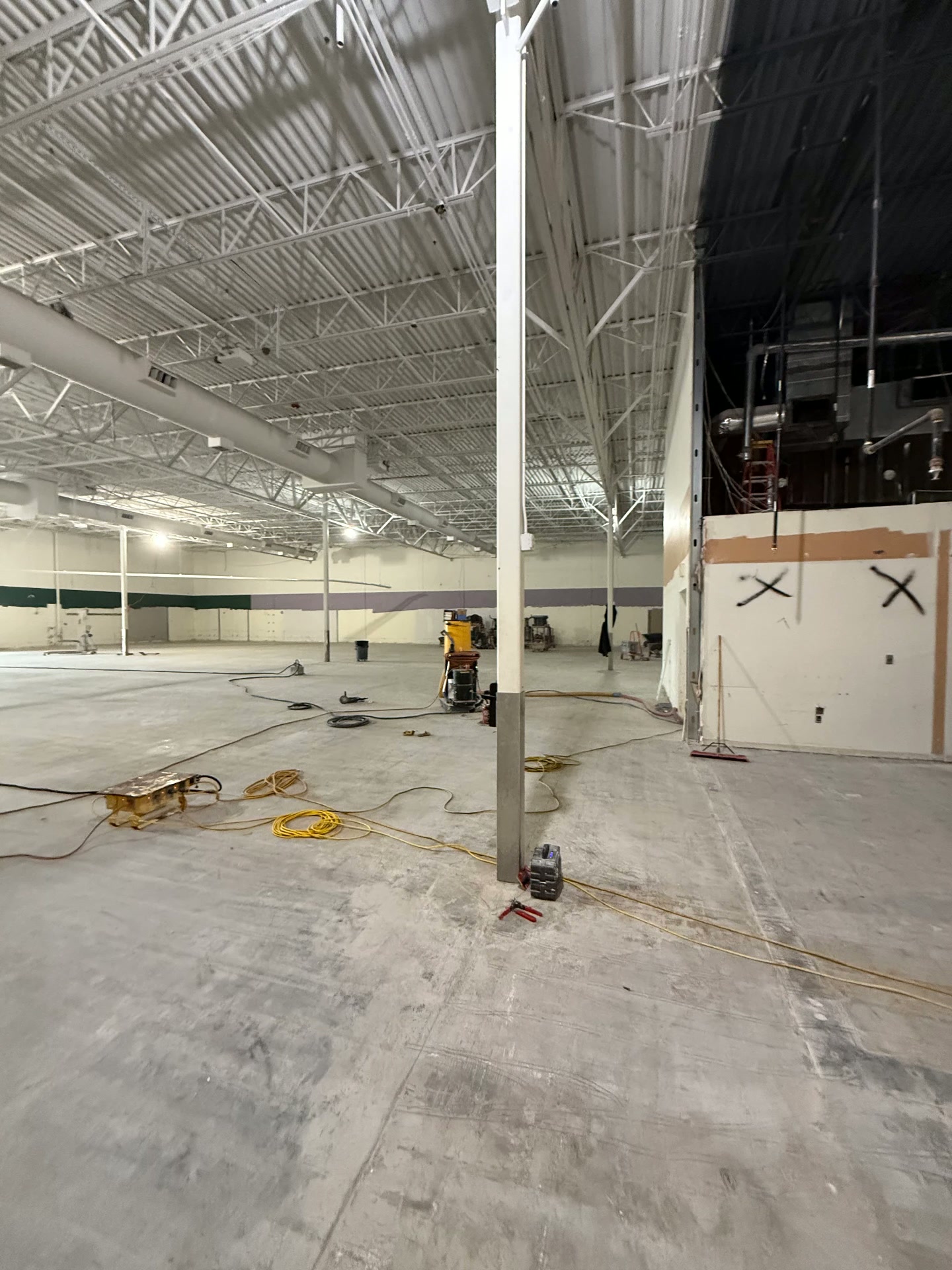 Commercial interior strip-out with exposed ceiling and concrete slab